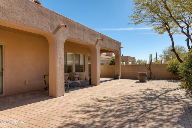 view of patio / terrace featuring fence