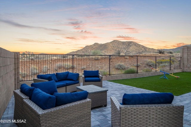 view of patio featuring outdoor lounge area, a fenced backyard, and a mountain view