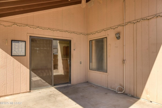 entrance to property featuring a patio