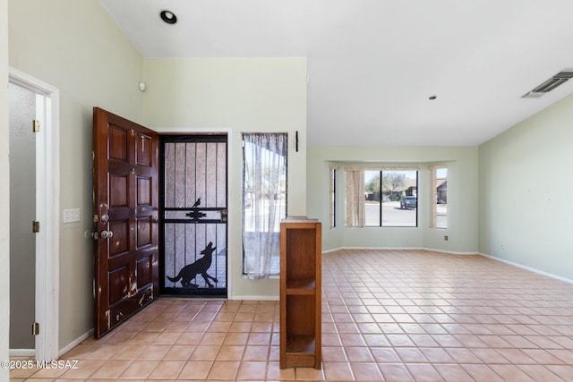 foyer with light tile patterned floors, visible vents, and baseboards