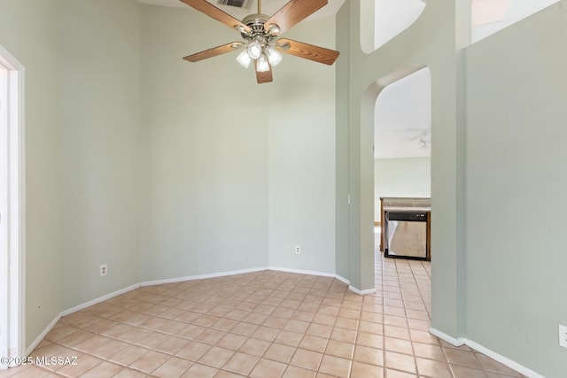 unfurnished room with ceiling fan, light tile patterned flooring, visible vents, and baseboards