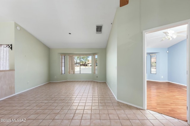 unfurnished room with light tile patterned floors, baseboards, visible vents, and a ceiling fan