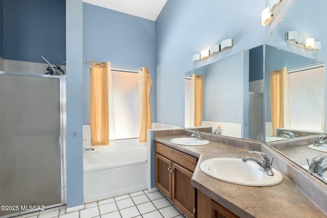 bathroom featuring double vanity, tile patterned floors, a sink, a shower stall, and a bath