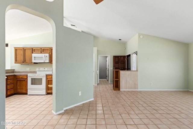 kitchen featuring white appliances, visible vents, arched walkways, brown cabinetry, and vaulted ceiling