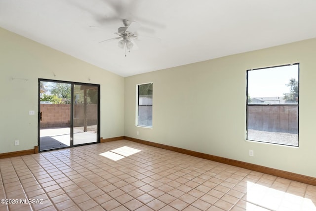 spare room featuring lofted ceiling, ceiling fan, baseboards, and light tile patterned floors