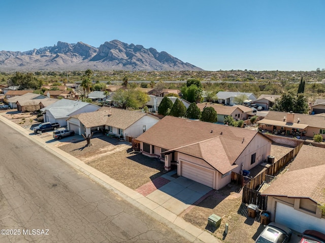 drone / aerial view featuring a residential view and a mountain view