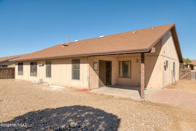 rear view of property with a patio area and fence