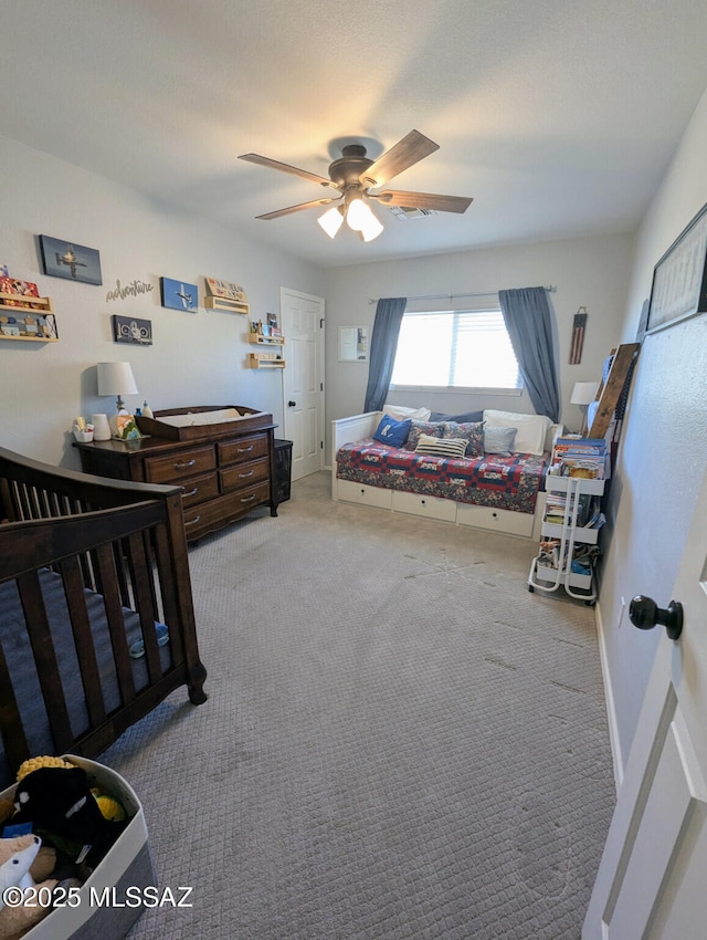 bedroom featuring baseboards, visible vents, a ceiling fan, and carpet flooring