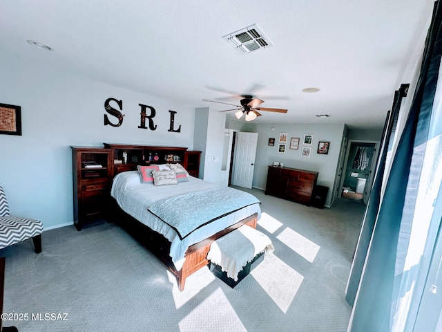 bedroom with light carpet, ceiling fan, and visible vents