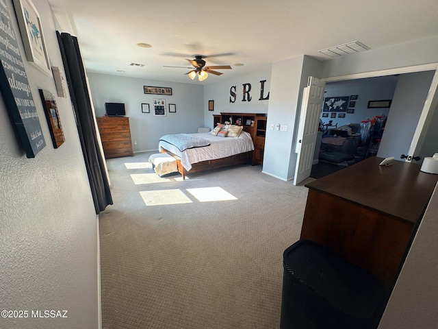 carpeted bedroom featuring baseboards, visible vents, and a ceiling fan