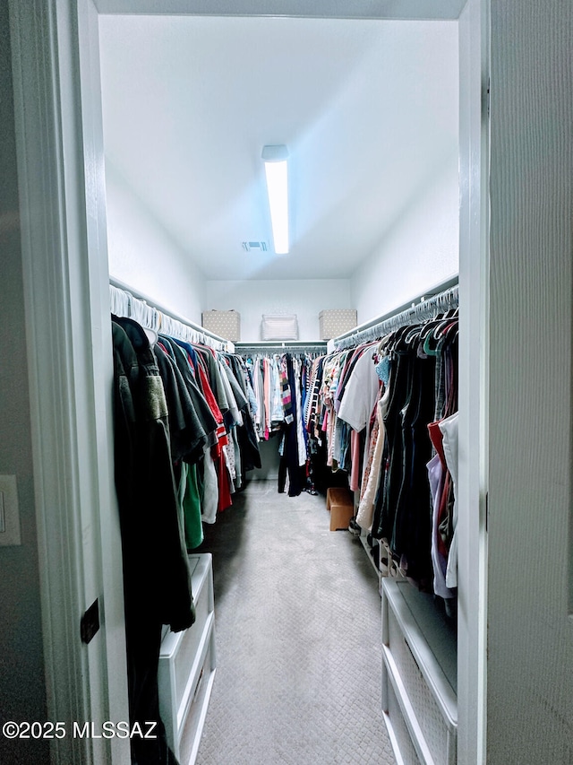 spacious closet with carpet and visible vents