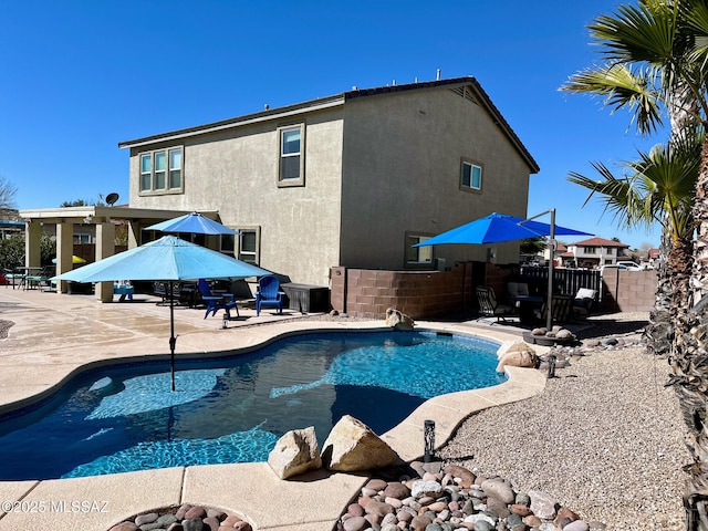 view of swimming pool with a fenced in pool, a patio, and fence