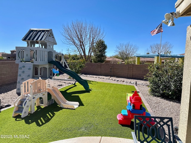 view of jungle gym featuring a fenced backyard and a lawn