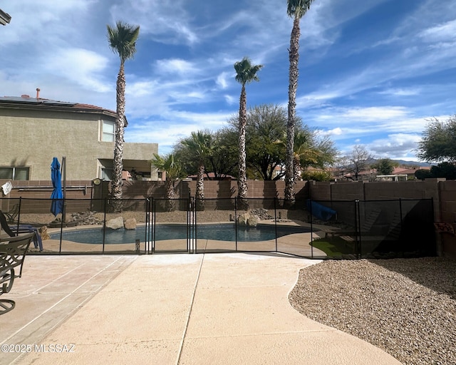 view of basketball court featuring fence and a fenced in pool