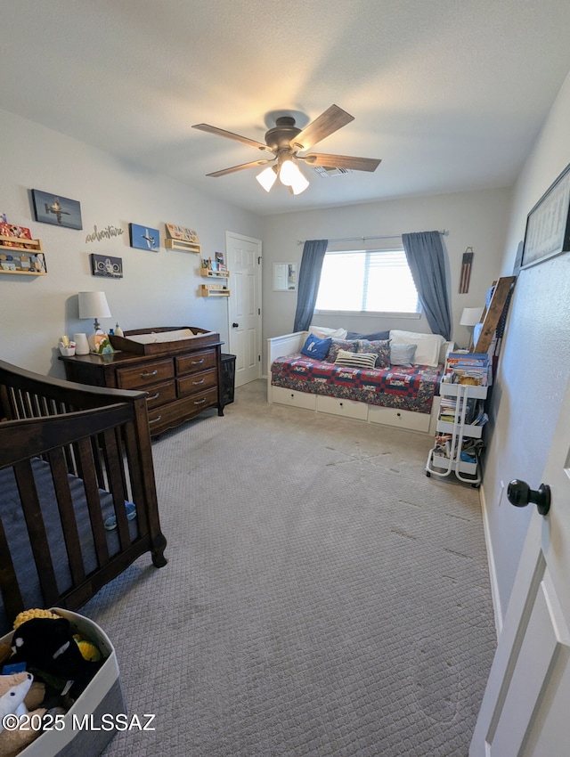 bedroom with baseboards, carpet flooring, visible vents, and a ceiling fan