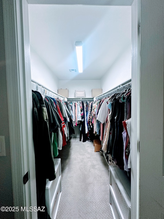 spacious closet featuring carpet floors and visible vents