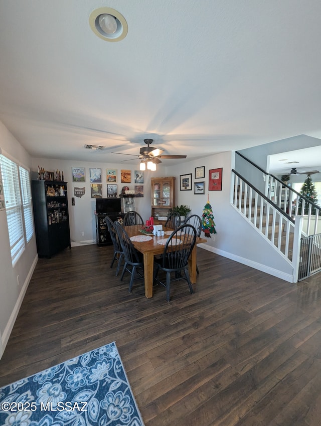 dining space with a ceiling fan, stairway, baseboards, and wood finished floors