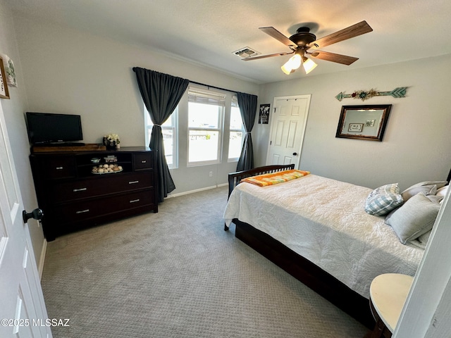 bedroom with light colored carpet, ceiling fan, visible vents, and baseboards