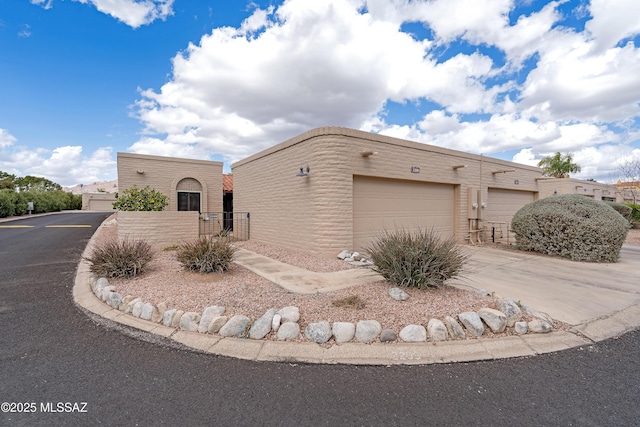 view of front of property featuring a gate and driveway