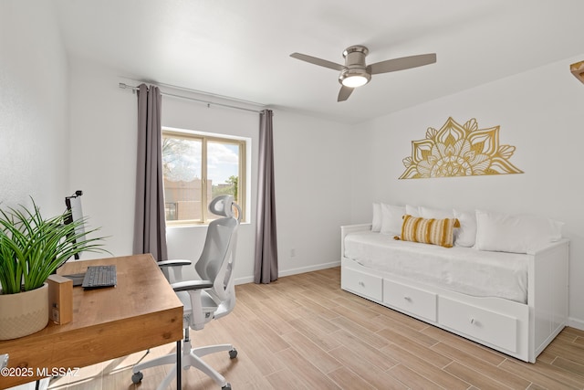 office area featuring baseboards, wood finish floors, and a ceiling fan