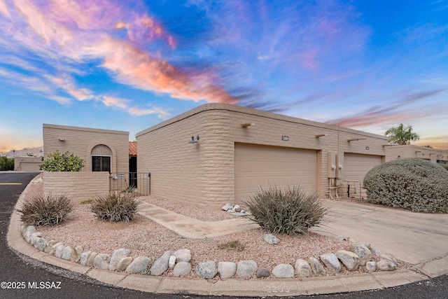 view of front of house featuring concrete driveway and a garage