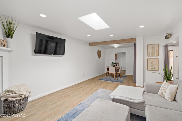 living area featuring recessed lighting, a skylight, baseboards, and wood finished floors