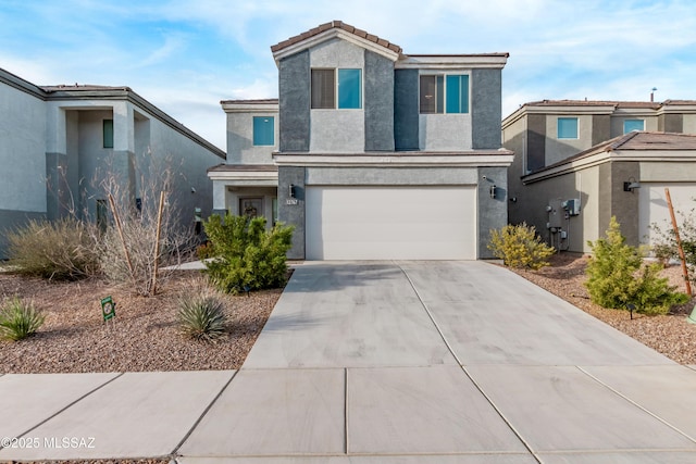 view of front facade featuring concrete driveway, an attached garage, a tiled roof, and stucco siding