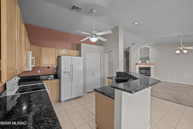 kitchen with white appliances, light tile patterned floors, open floor plan, and a sink