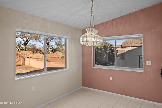 unfurnished dining area with baseboards