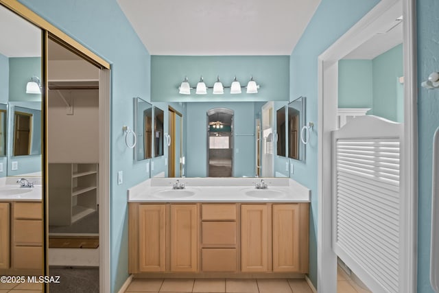 bathroom featuring double vanity, tile patterned flooring, and a sink