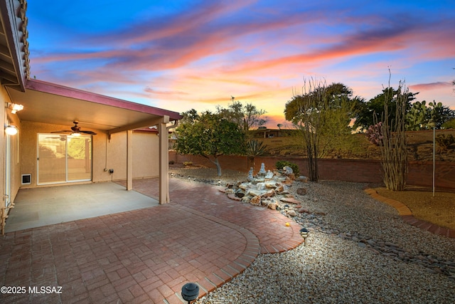 view of patio with a fenced backyard and ceiling fan