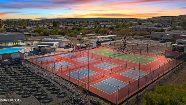 aerial view at dusk featuring a mountain view