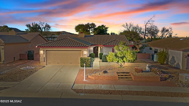 view of front facade with a tile roof, a chimney, stucco siding, concrete driveway, and an attached garage