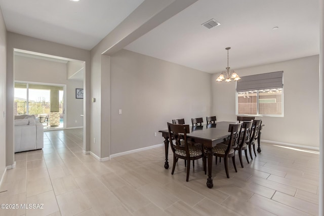 dining space with a notable chandelier, visible vents, and baseboards