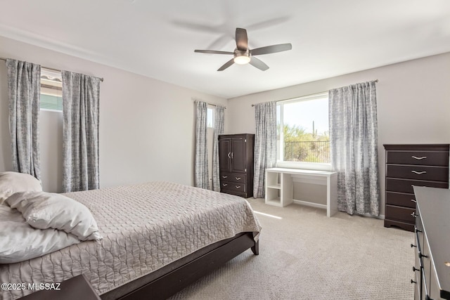 bedroom with ceiling fan and light carpet