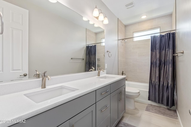 full bathroom featuring double vanity, shower / bath combo, visible vents, and a sink