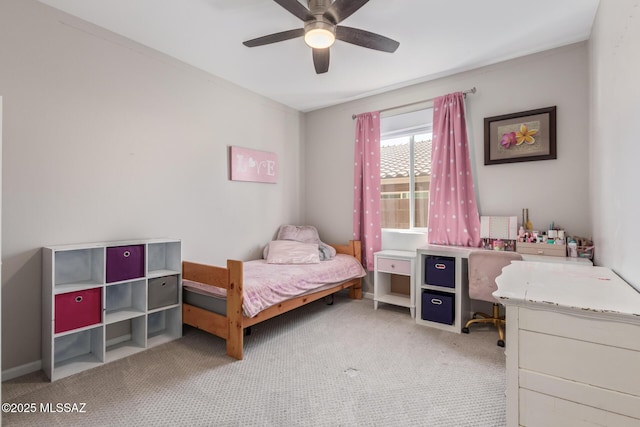 bedroom with a ceiling fan, baseboards, and light carpet