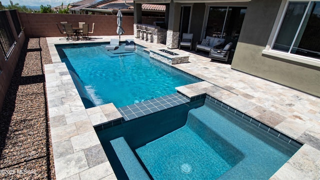 view of pool with a patio, a fenced in pool, an in ground hot tub, a fenced backyard, and outdoor dry bar