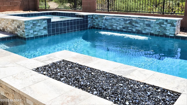 view of pool with a fenced in pool and an in ground hot tub