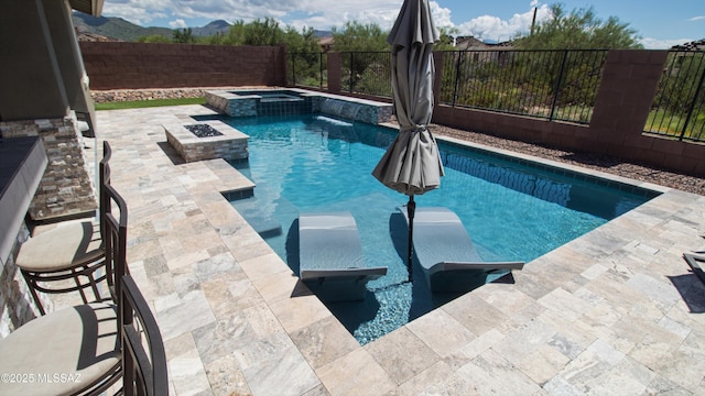 view of pool with a patio, a fenced backyard, and a pool with connected hot tub