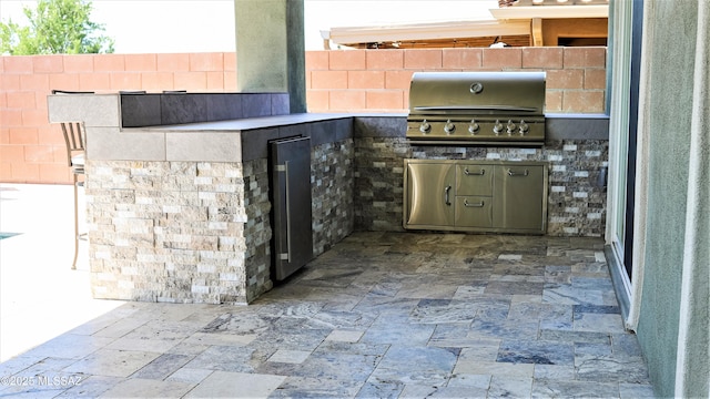 view of patio / terrace featuring area for grilling, an outdoor kitchen, and fence