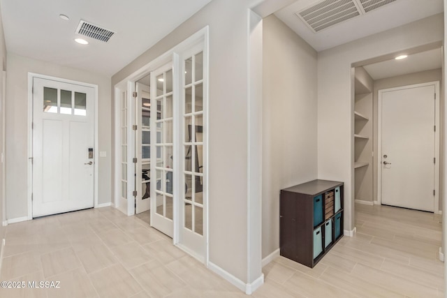 foyer with visible vents, recessed lighting, and baseboards