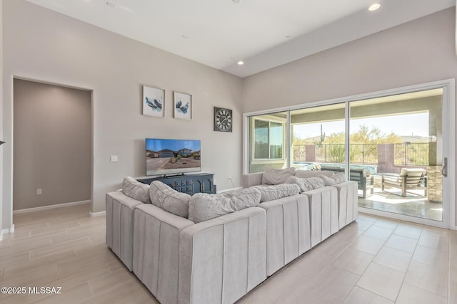 living room with recessed lighting and baseboards