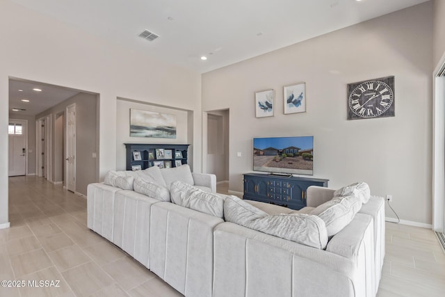 living room featuring recessed lighting, baseboards, and visible vents