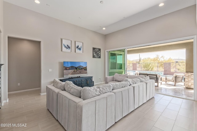 living room with recessed lighting and baseboards