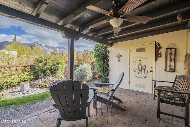 view of patio featuring visible vents, a mountain view, and ceiling fan