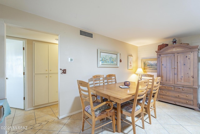 dining area featuring light tile patterned floors, visible vents, and baseboards