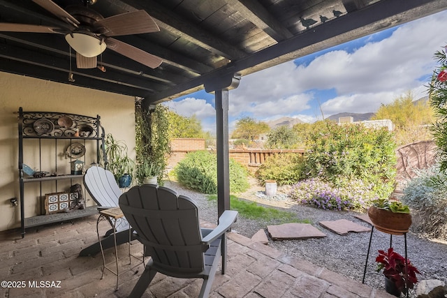 view of patio / terrace featuring outdoor dining area, fence, and a ceiling fan