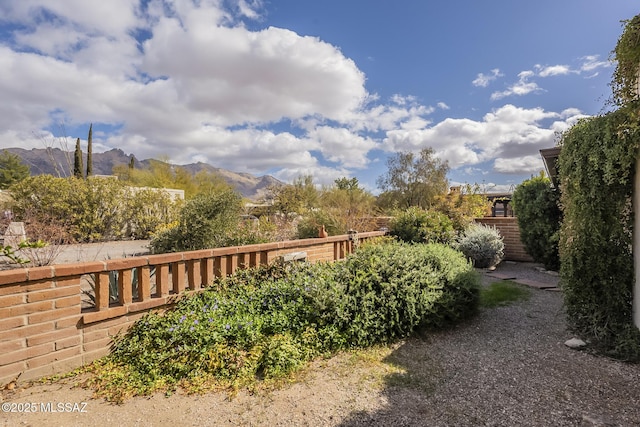 view of property's community with a mountain view and fence