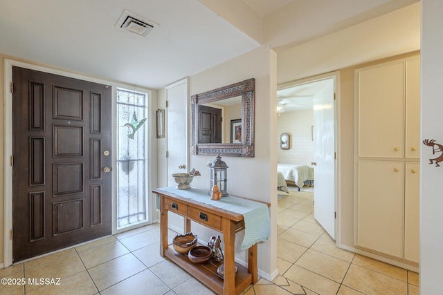 entryway with light tile patterned floors and visible vents